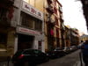 picture of la base in Barcelona with cars in front and a man and child on the right
